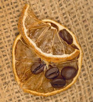 Royalty Free Photo of Lemons and Coffee Beans on Burlap