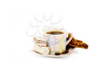 Coffee cup with sweets an cinnamon on white background