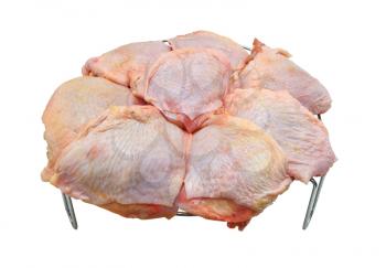 Chicken gammons lie on a metal lattice for a frying