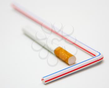 One cigaret and tubule for juice on a white background