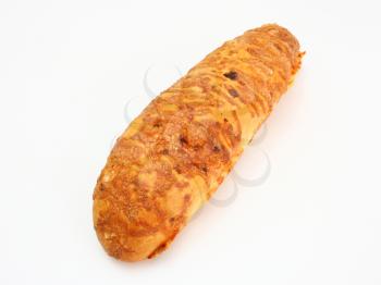 The ruddy long loaf of bread is strewed by cheese isolated on a white background