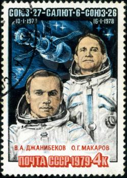 USSR - CIRCA 1978: A post stamp printed in USSR shows famous Russian astronauts Dzhanibekov and Makarov with inscriptions and name of series Soyuz 27, Salyut 4, Soyuz - 27 spaceships, circa 1978