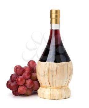 Full red wine bottle and grapes isolated on white background