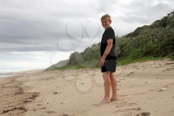 Happy Boy on Vacation Walking on Beach