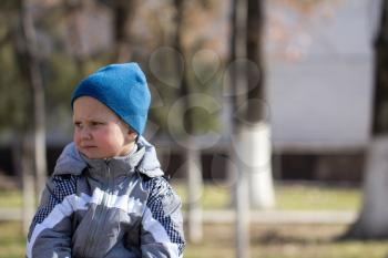 boy in a blue cap on nature