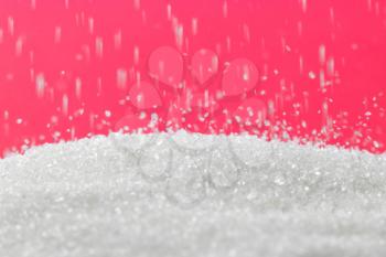 sugar on a red background. macro