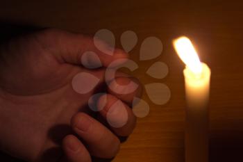 dead hand and the light from the candles