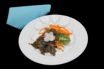 Korean carrot salad and seaweed on a black background