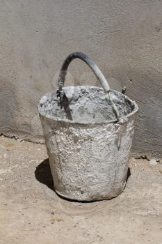 bucket against the concrete wall
