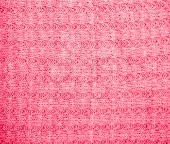 background of red knitted fabric. texture