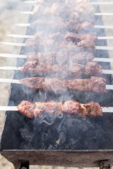 Meat on the grill in the open air .