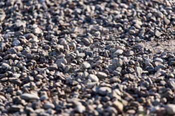 Crushed stone on the road as a background .