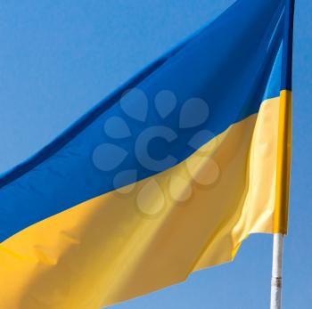 flag of Ukraine against the blue sky .