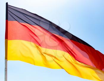 Flag of Germany against the blue sky .