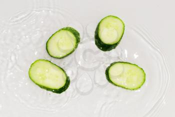 cucumber in the water on a white background