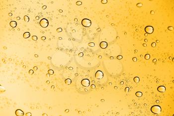 golden water drops on glass