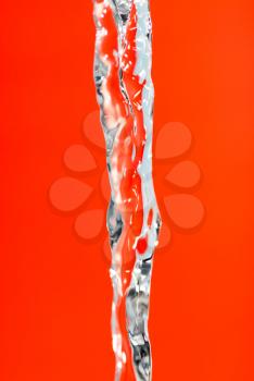 a jet of water on a red background