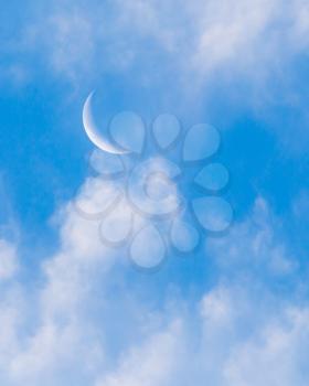 moon on a blue sky with clouds