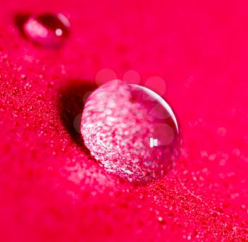 a drop of water on a red background. close