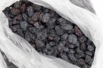 Black raisins in a plastic bag