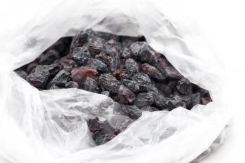 Black raisins in a plastic bag