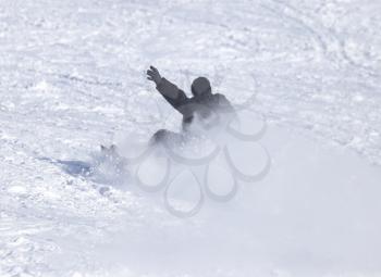 People fell on a snowboard in the snow in the winter