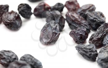 Black raisins on a white background. macro