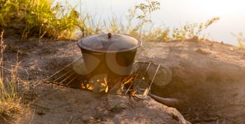 cauldron on fire at sunset