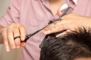 men's haircut with scissors at salon
