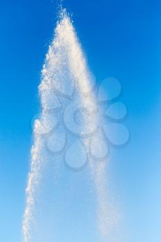 water splashing from the fountain in the background of blue sky