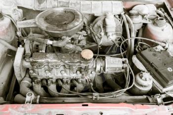 motor and hoses under the hood of car