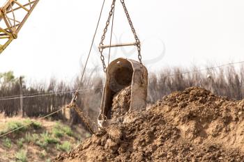 excavator digging a big bucket