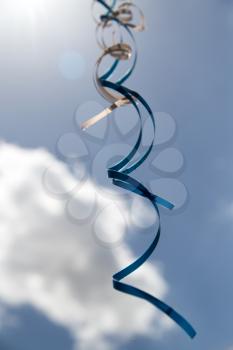 festive ribbon on a background of blue sky