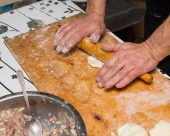 man prepares dumplings at home