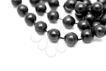 Black beads on a rope on a white background