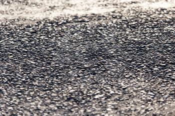 Old black asphalt on the road as background