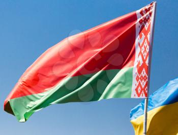 Flag of Belarus against the blue sky .