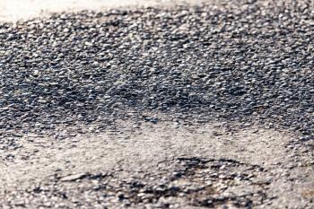 Old black asphalt on the road as background