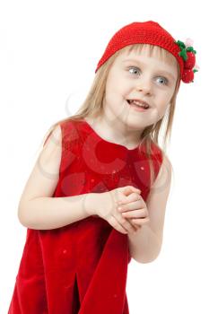 Portrait of a little girl in a red dress and a knitted cap with a strawberry pattern
