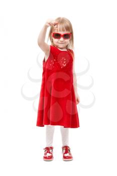 Charming girl in red dress and sunglasses show delicious candy. In the studio, isolated on white background