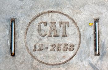 Concrete manhole in Bangkok with the words CAT 12-2553