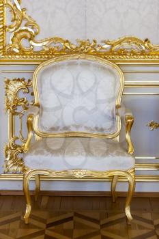 Elegant antique chair decorated with gold leaf in the Palace's Central