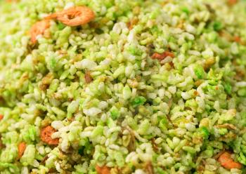 Green rice with shrimp close-up on the market in Thailand