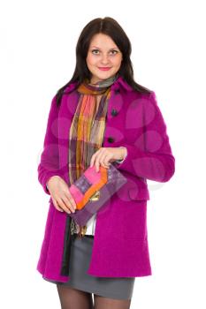 Beautiful girl in a purple coat with a trendy clutch bag in her hands. Studio, isolate on a white background. High-resolution image Canon 5d mark3, 22 megapixels.