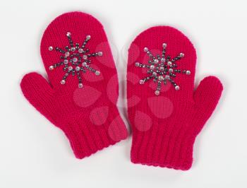 Gloves are a pair of red knit with crystals on a gray background
