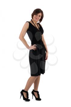 Attractive young woman in a black dress smiling and looking at camera. Isolate on white.