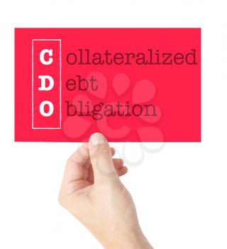 Collateralized Debt Obligation explained on a card held by a hand