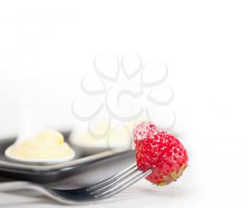 custard pastry cream and strawberry on a fork