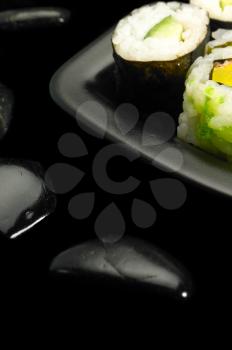 fresh colorfull assorted sushi plate over black