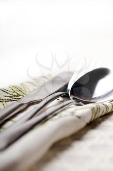 knife fork and spoon macro on napkin over a table DOF